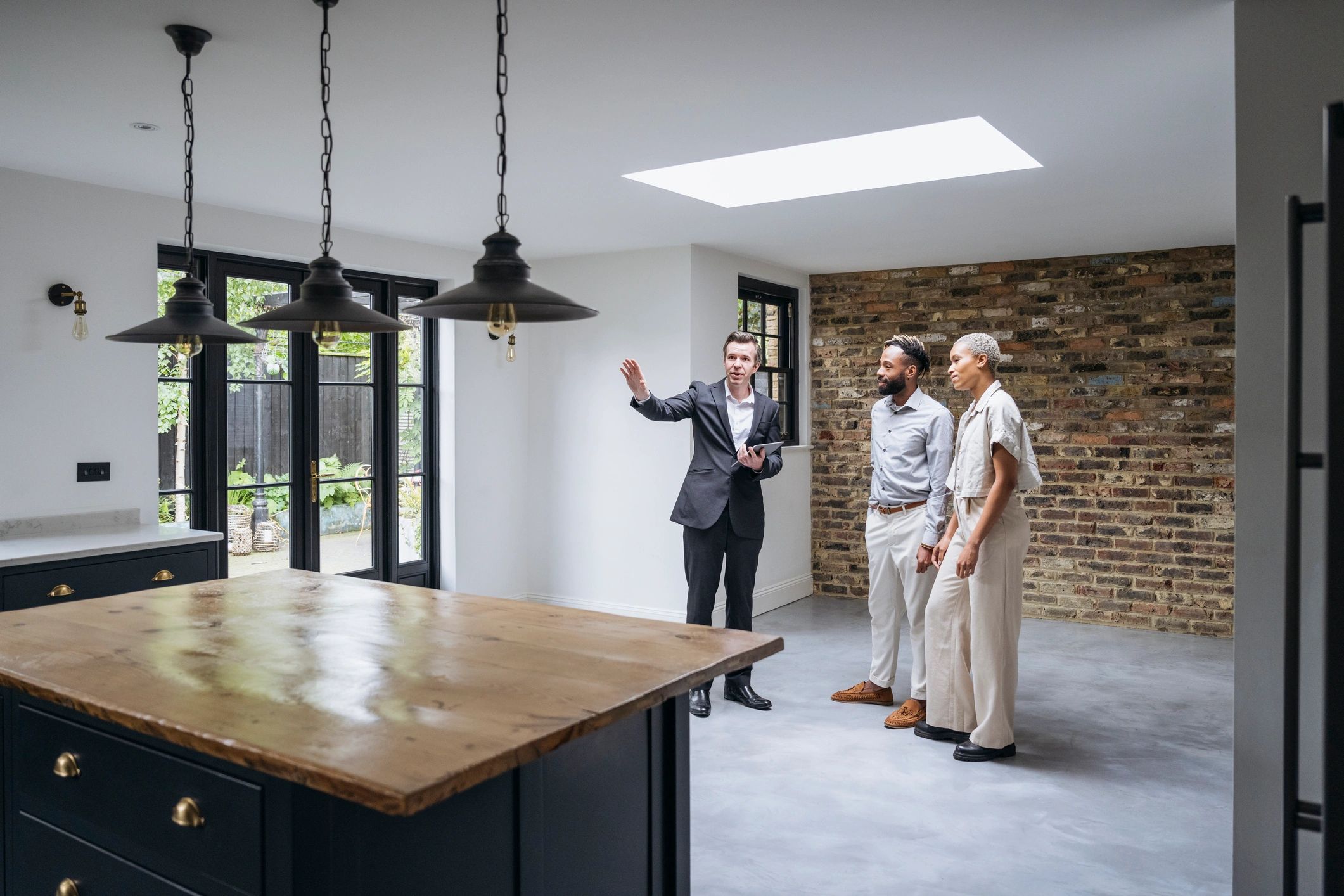 Real estate agent showing a home to buyers