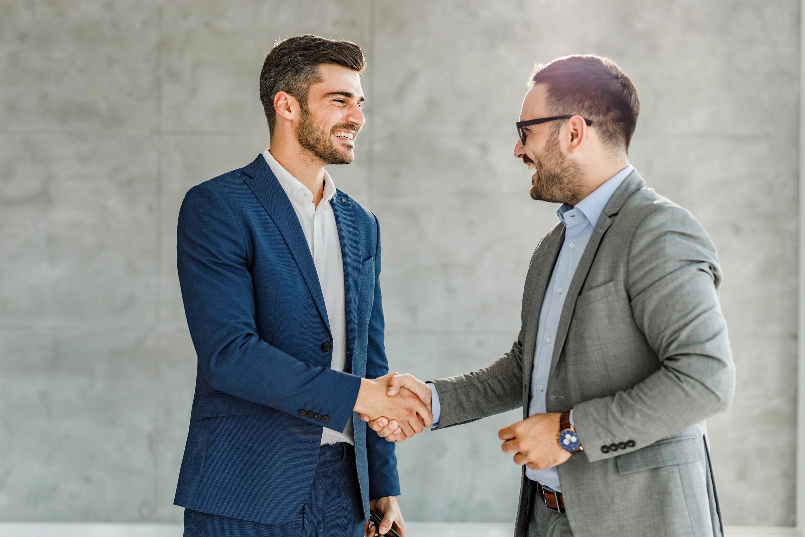 Two professionals shaking hands after reaching an agreement