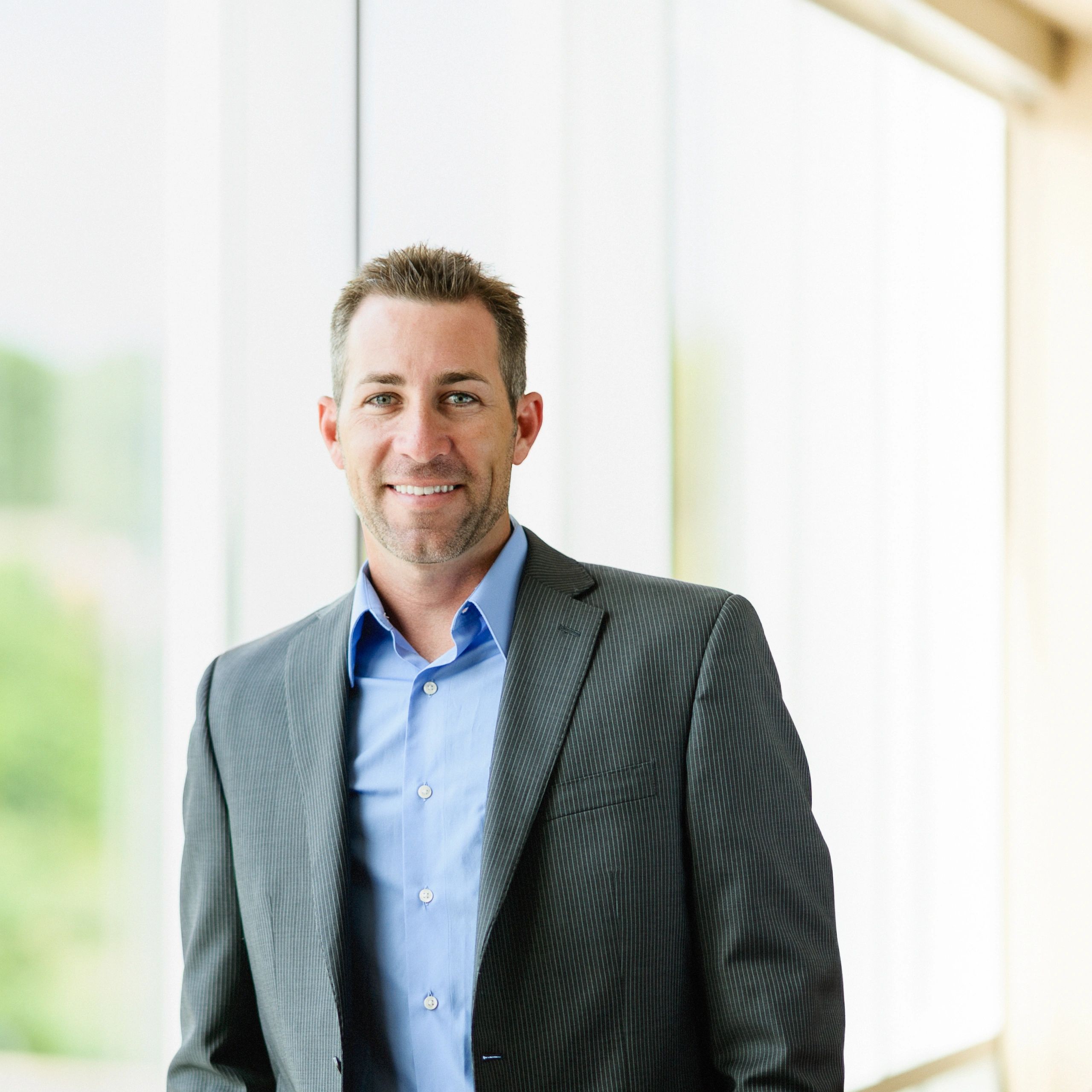 Professional headshot of a market analyst