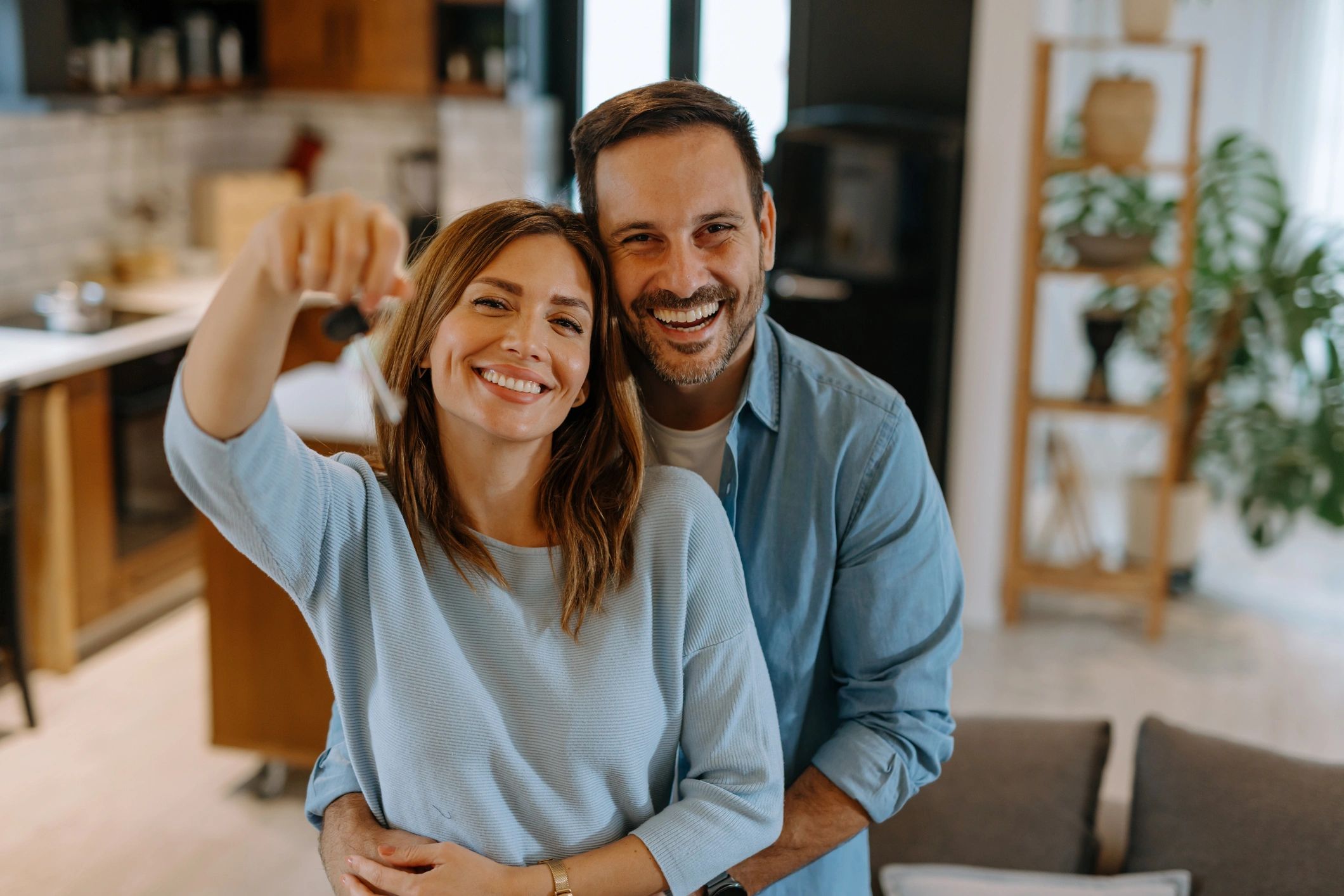 Happy couple holding keys to their new home