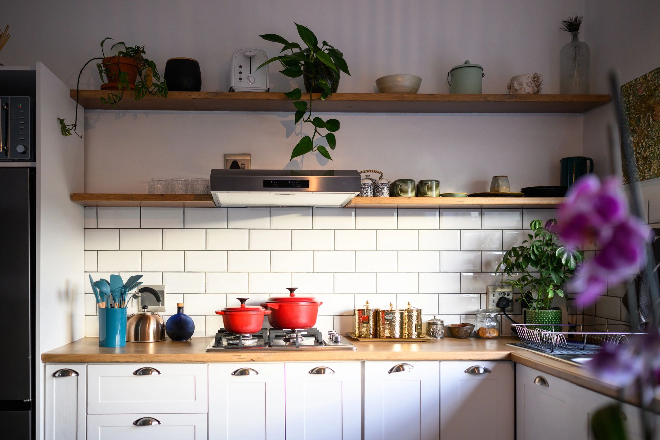 Bright modern kitchen with white cabinets and clean backsplash