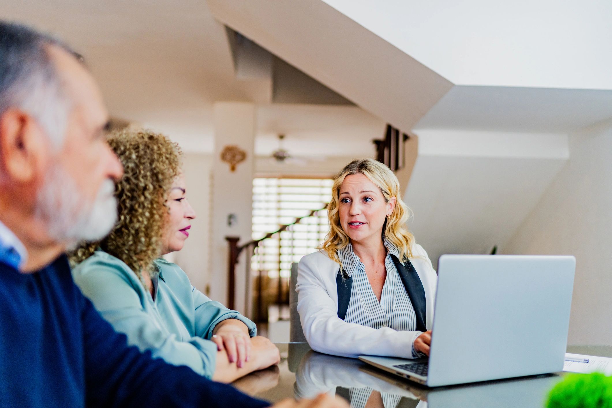 Advisor meeting with clients at a table to review options