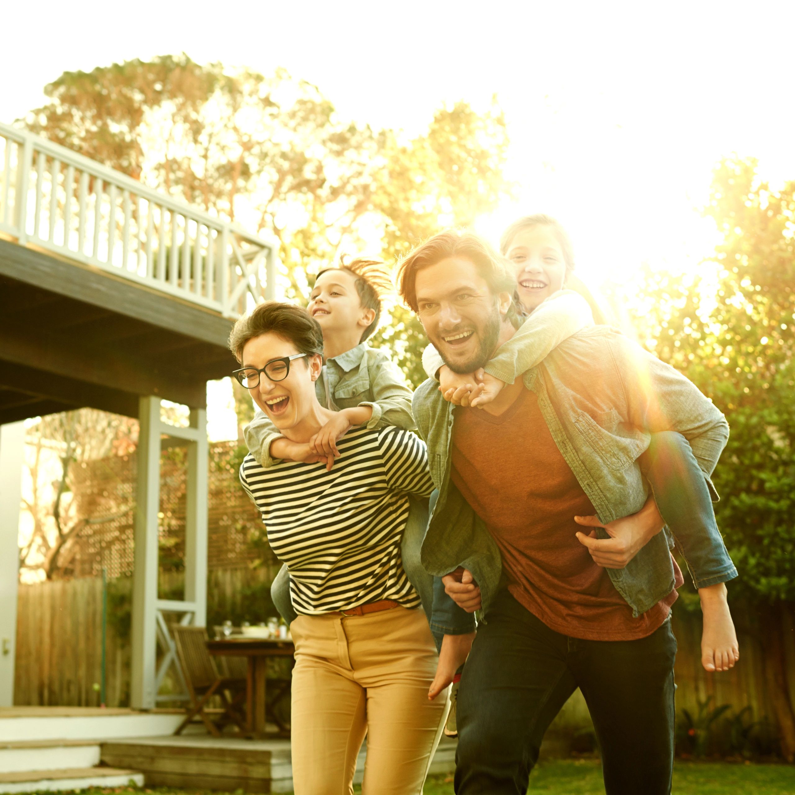 Happy family in a backyard after moving into a new home